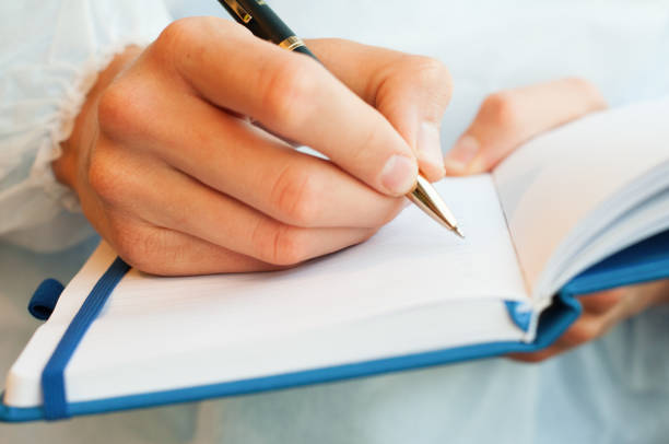 istock close-up of a hand writing in a Notepad 1278779009
