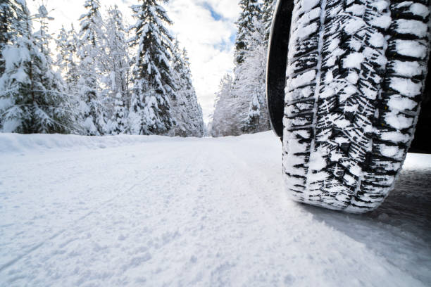 wintertyres on snow covered road stock photo