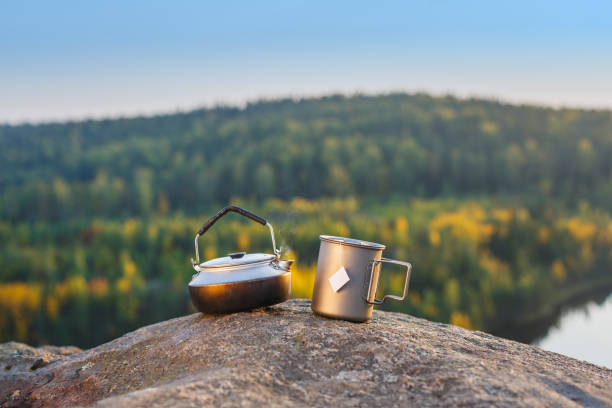 istock Kettle and mug on a rock on a background autumn forest. 1278779147