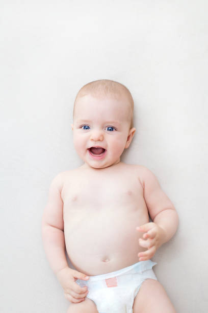 istock Cute baby girl lying on bed 1278779151
