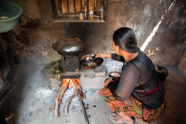 istock Balinese Woman Cooking Over Fire 1278779333
