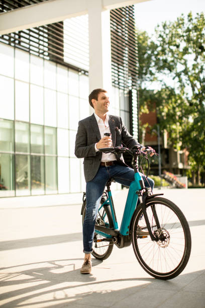istock Young businessman on the ebike with takeaway coffee cup 1278779424