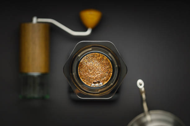 istock Aeropress coffee maker with scales, coffee grinder and kettle on a black background top view. 1278779469