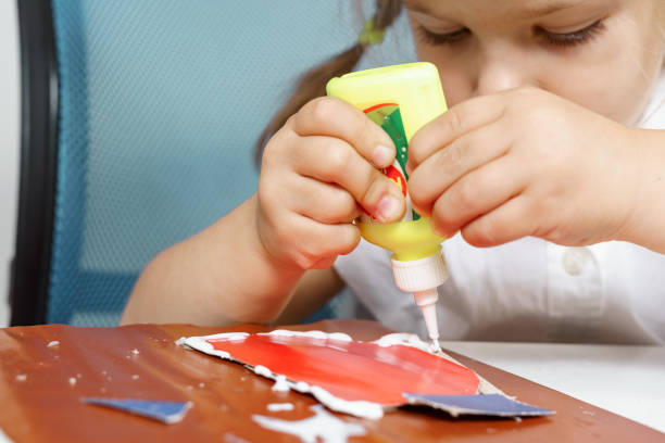 children's creativity. child glues colored paper children's creativity. child glues colored paper preschooler caucasian one person part of stock pictures, royalty-free photos & images