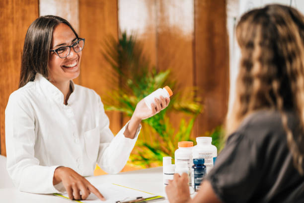 Functional Medicine Female Practitioner Recommending Dietary Supplement to a Client