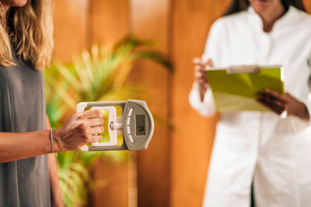 Handgrip Strength Test with Digital Hand Dynamometer at a Functional Medicine Center Handgrip strength test with digital hand dynamometer at a functional medicine center dynamometer stock pictures, royalty-free photos & images