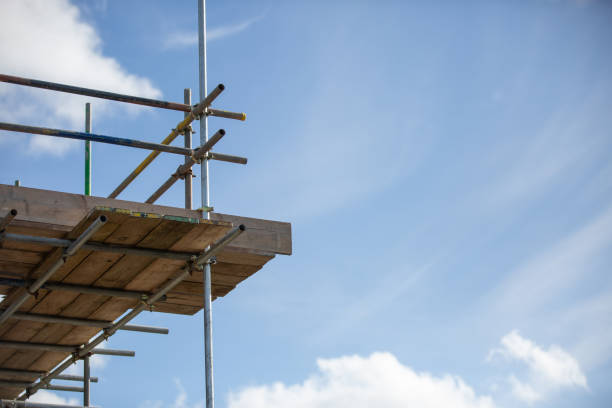 Scaffolding erected for a residential build with bright blue sky in the distance stock photo