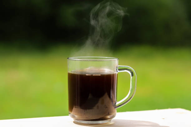 istock A glass transparent cup with black coffee, from which steam is rising. 1278786122