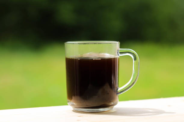 istock A glass transparent cup with black coffee, from which steam is rising. 1278786160