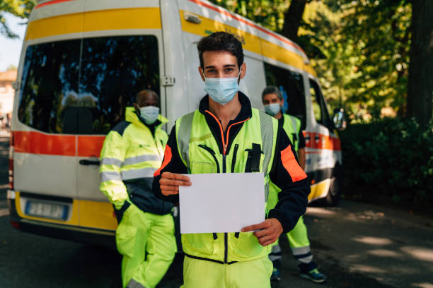 istock Paramedic is holding a blank sheet in front of the camera 1278786364
