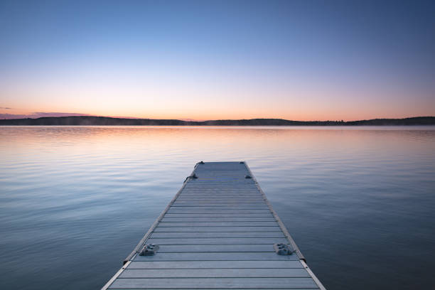 istock Small boat pier on a calm lake 1278787278