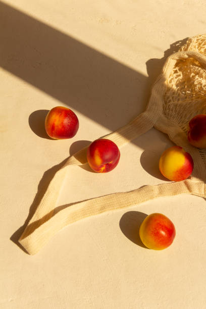 istock Fresh juicy nectarines in a cotton bag on a white background 1278787482