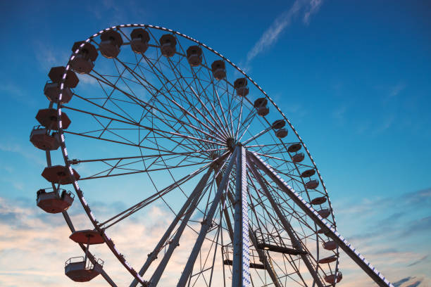 istock Ferris Wheel with sunset sky and clouds 1278788977