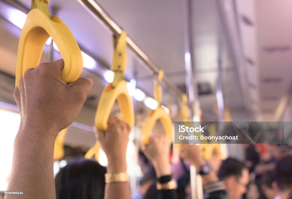 People hand holding handle on the bus Bus Stock Photo