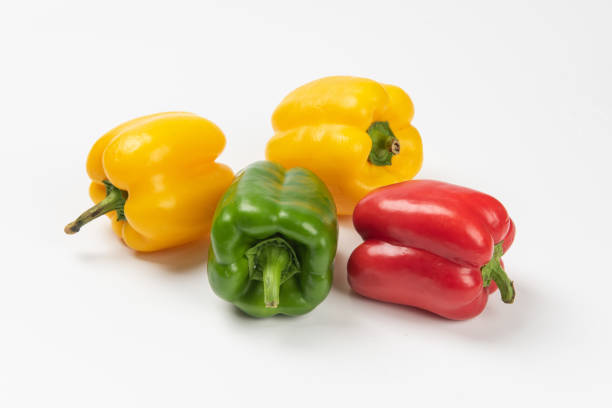 istock Fresh ripe color bell peppers isolated on white background 1278789373