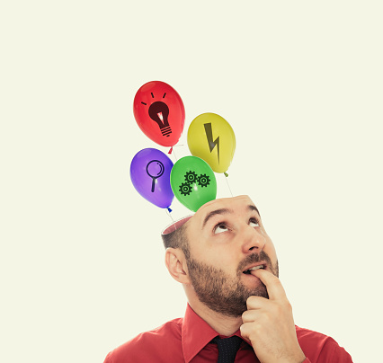 Balloons fly out of the man's head. The concept of a new idea.