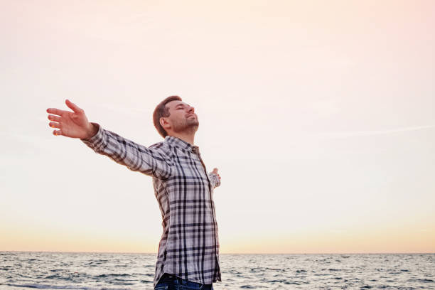 istock Happy young man standing with arms outstretched 1278790835