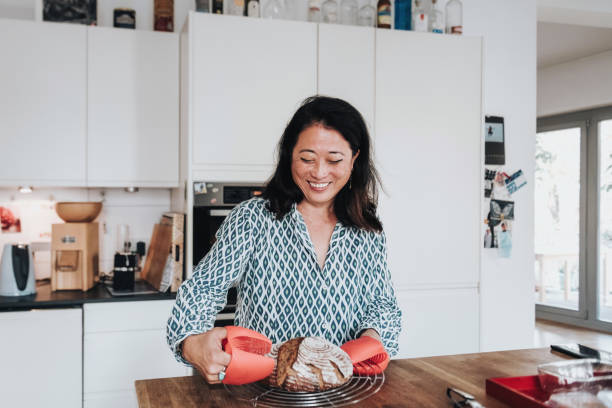 woman putting home made warm bread on kitchen table