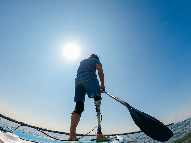 istock Amputee man paddle boarding in sea 1278795158