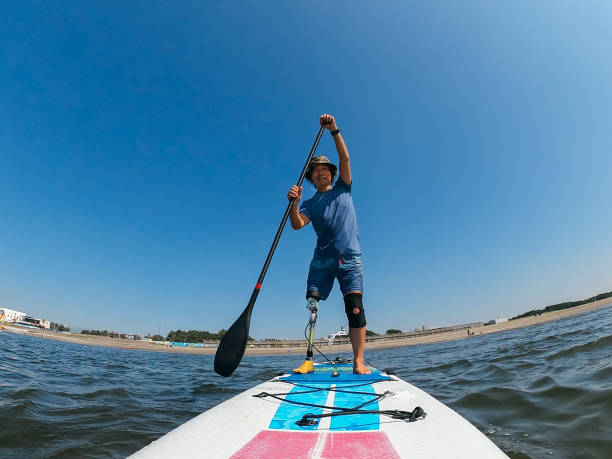 istock Amputee man paddle boarding in sea 1278795169