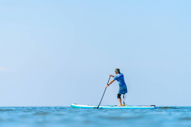 istock Amputee man paddle boarding in sea 1278795220