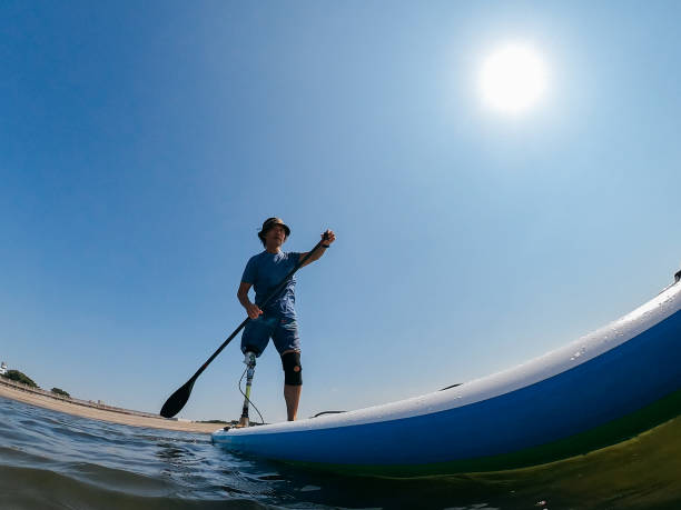 istock Amputee man paddle boarding in sea 1278795229