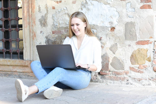 istock Young beautiful woman working on laptop, outdoor 1278796449