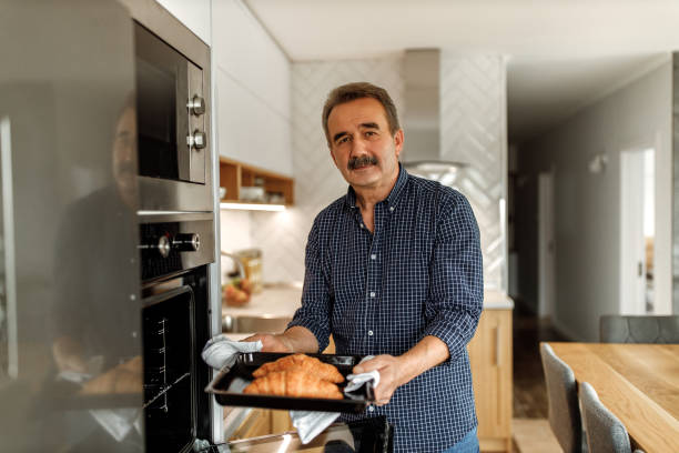 istock Baking croissants in the oven. 1278796736