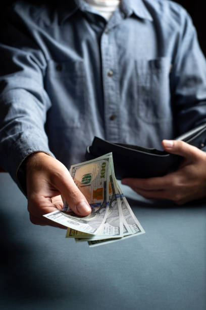 istock Man taking out cash from a leather wallet closeup 1278798162