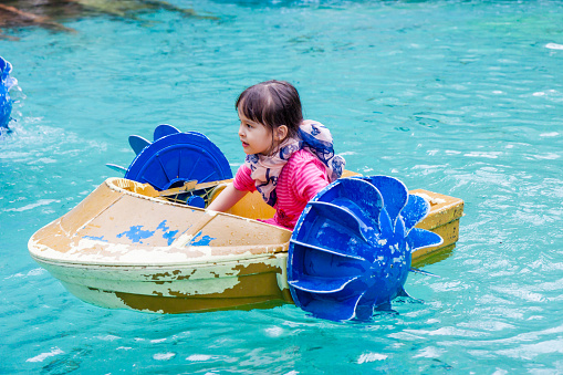 Young girl in hand paddle boat