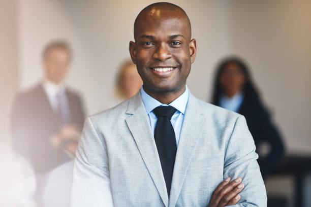 istock Smiling African businessman standing in an office 1278799011