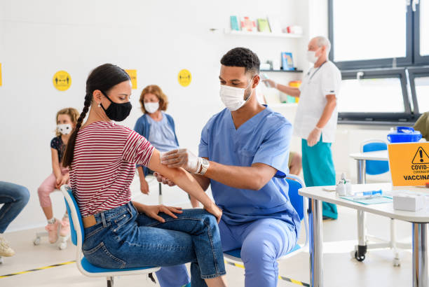 Woman with face mask getting vaccinated, coronavirus, covid-19 and vaccination concept. Young woman with face mask getting vaccinated, coronavirus, covid-19 and vaccination concept. covid 19 vaccine photos stock pictures, royalty-free photos & images