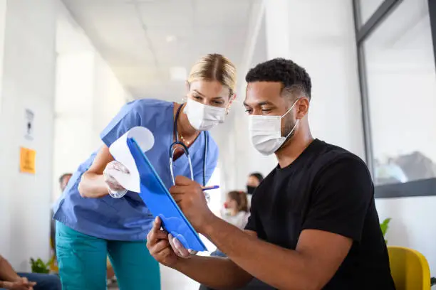 Photo of Portrait of nurse and man with face masks, coronavirus, covid-19 and vaccination concept.