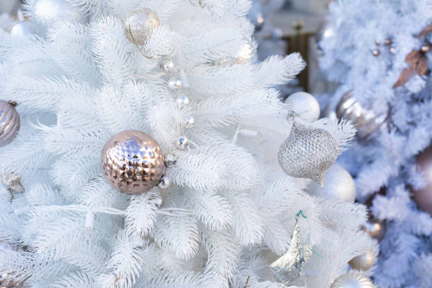 istock Christmas decoration, artificial white Christmas tree with a golden ball. Festive background 1278800564