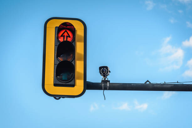 istock Traffic light and a camera on blue sky background. Traffic control concept. 1278802549