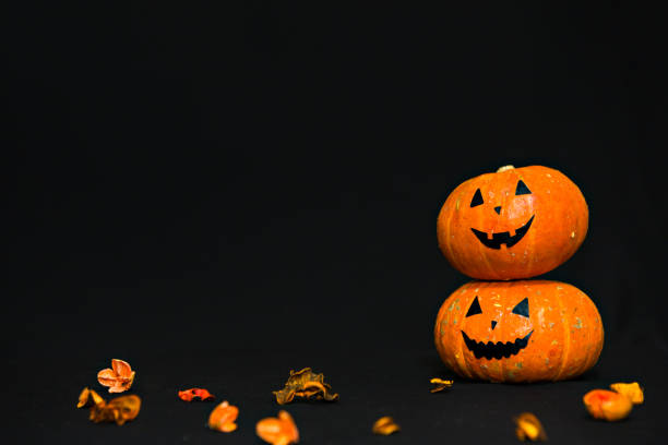 istock Two pumpkins on black background. Happy Halloween 1278802896