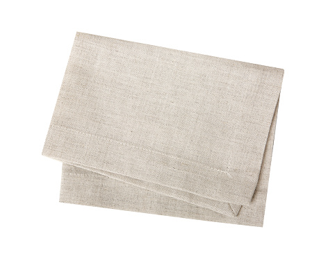 Kitchen towel isolated on white.Folded beige cloth.Tablecloth.