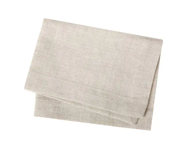 Kitchen towel isolated on white.Folded beige cloth.Tablecloth.