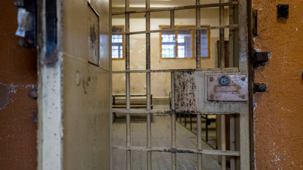 istock Light Coming in Through Prison Cell Bars Window. Empty Jail Cells. Prison Interior. Concept of Limiting Freedom. 1278805757