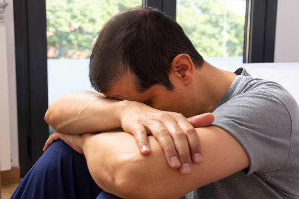 istock sad man sitting on a floor 1278805798