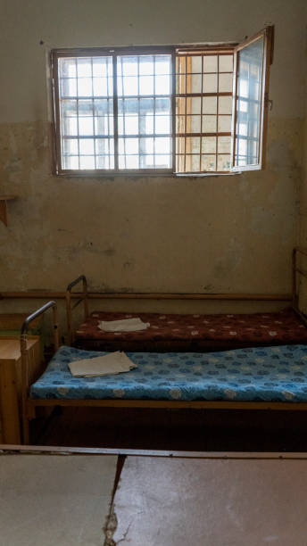 istock Light Coming in Through Prison Cell Bars Window. Empty Jail Cells. Prison Interior. Concept of Limiting Freedom. 1278805918