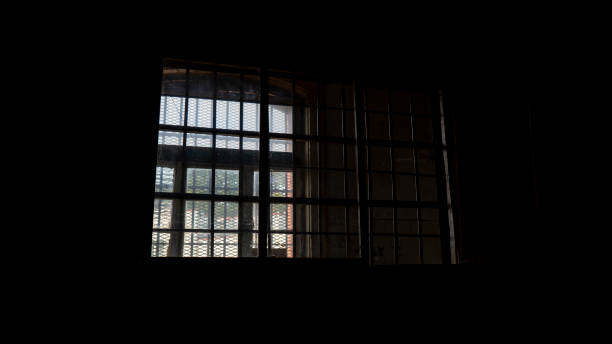 istock Light Coming in Through Prison Cell Bars Window. Empty Jail Cells. Prison Interior. Concept of Limiting Freedom. 1278805938