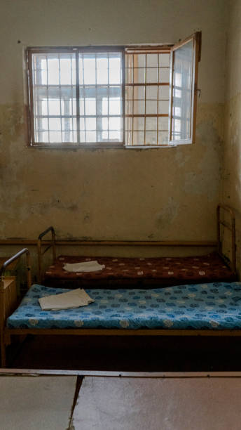istock Light Coming in Through Prison Cell Bars Window. Empty Jail Cells. Prison Interior. Concept of Limiting Freedom. 1278805943