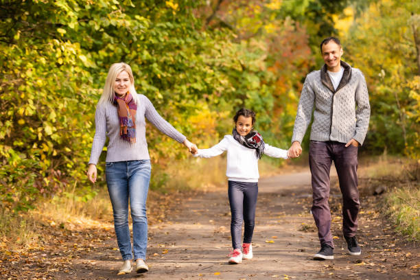 istock happy family Walking through autumn park 1278808501