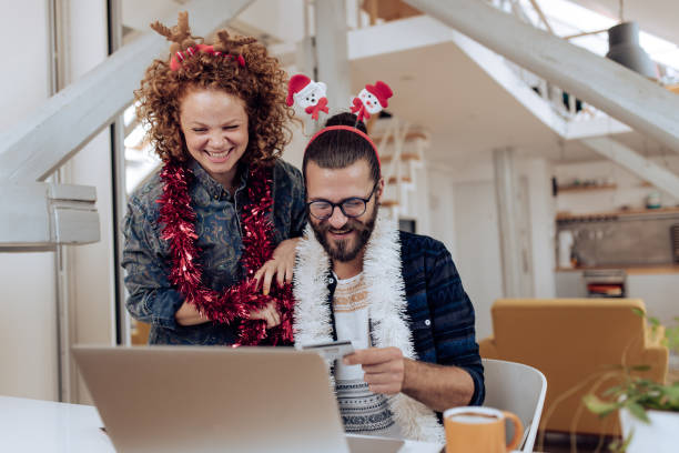 istock Young couple spending money online for Christmas 1278808798