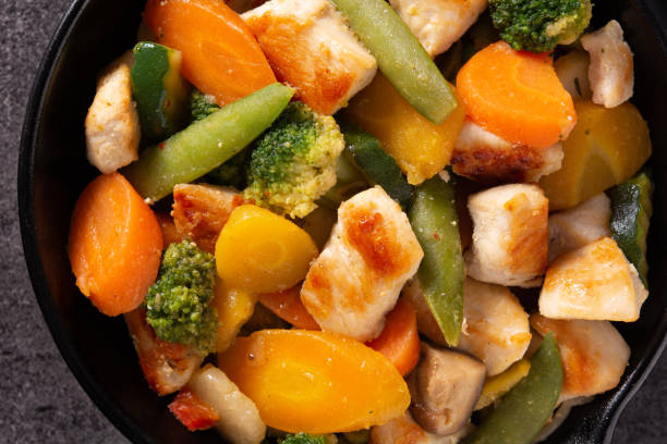 istock Stir fry chicken with vegetables on iron pan 1278812813