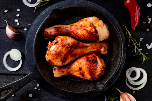 istock Fried chicken legs in a cast iron pan close up 1278812863