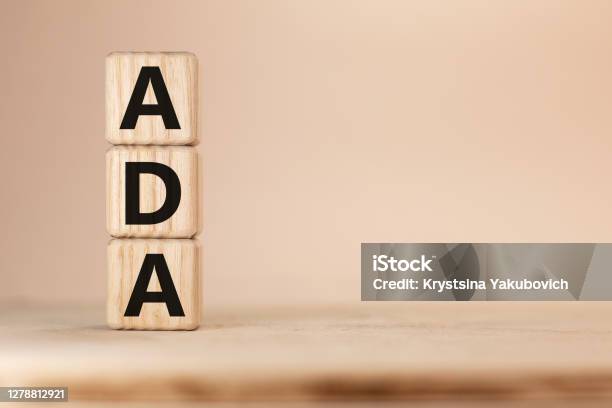 Word Ada Americans With Disabilities Acton Wooden Blocks Beige Background Top View Stock Photo - Download Image Now