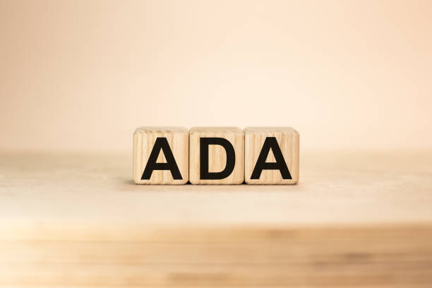 istock Word ADA Americans with Disabilities Acton wooden blocks beige background top view 1278812928