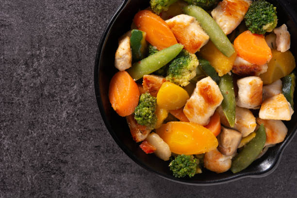 istock Stir fry chicken with vegetables on iron pan 1278812938